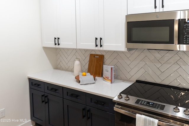 kitchen with white cabinetry, appliances with stainless steel finishes, and decorative backsplash