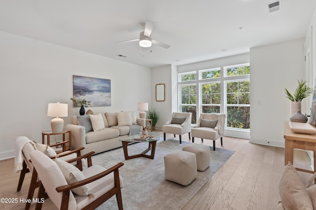 living room with ceiling fan and light hardwood / wood-style floors