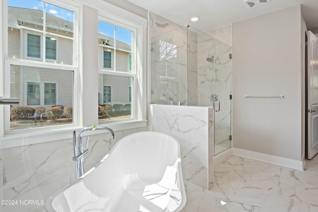 bathroom featuring separate shower and tub