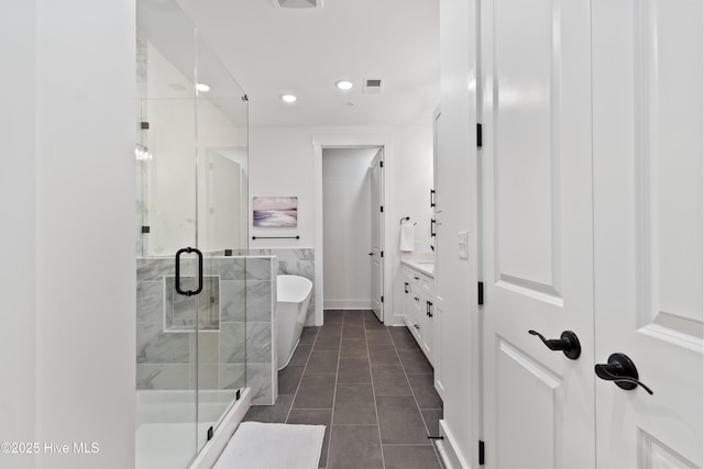 bathroom with tile patterned floors, vanity, and independent shower and bath