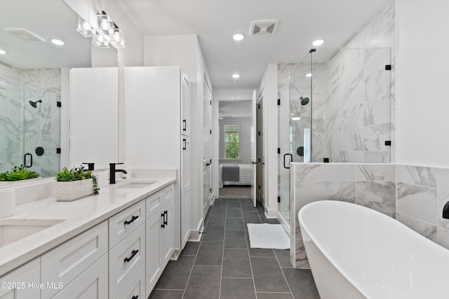 bathroom featuring tile patterned flooring, vanity, and shower with separate bathtub