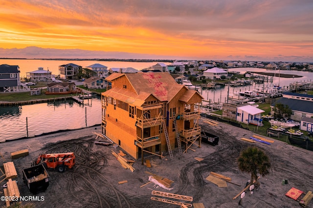 aerial view at dusk with a water view