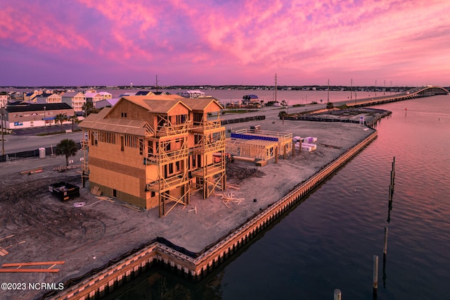 aerial view at dusk with a water view