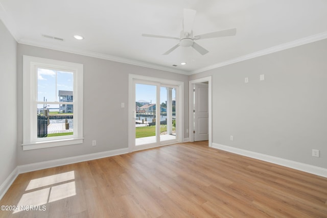 empty room with ceiling fan, light hardwood / wood-style flooring, and ornamental molding