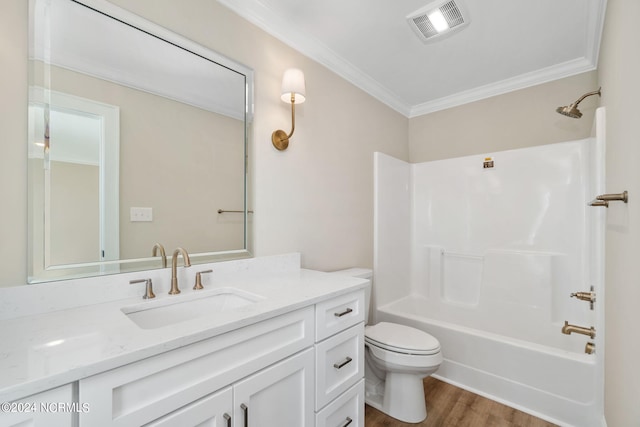 full bathroom with toilet, hardwood / wood-style floors, crown molding, vanity, and tub / shower combination