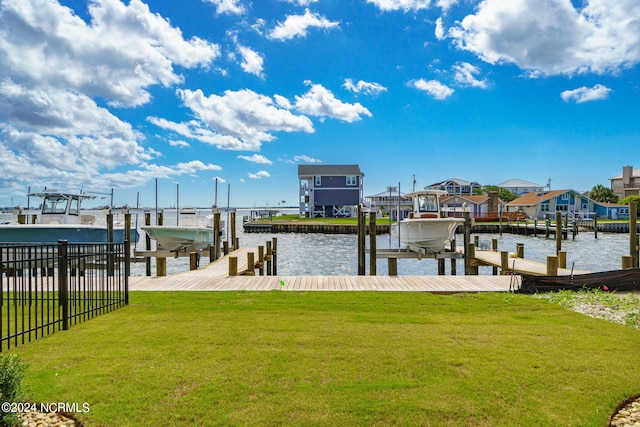 dock area featuring a yard and a water view