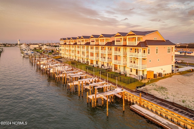 outdoor building at dusk featuring a water view