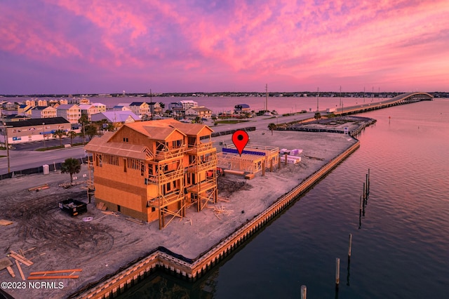 aerial view at dusk with a water view