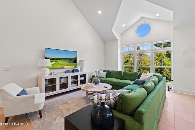 living room featuring light hardwood / wood-style floors and high vaulted ceiling