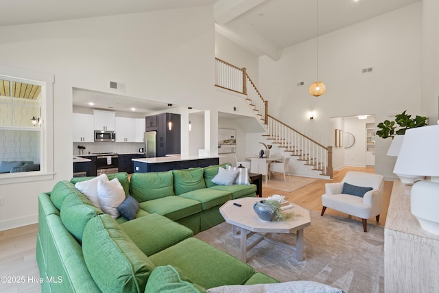 living room with lofted ceiling and light wood-type flooring