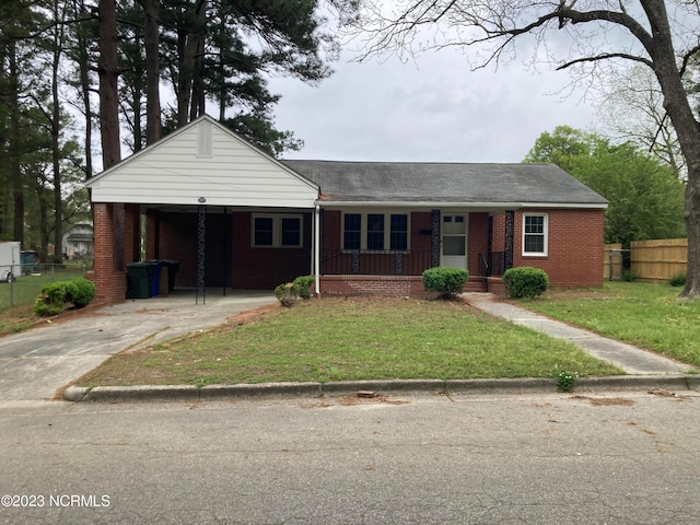 view of front facade with brick siding, concrete driveway, fence, a porch, and a front yard