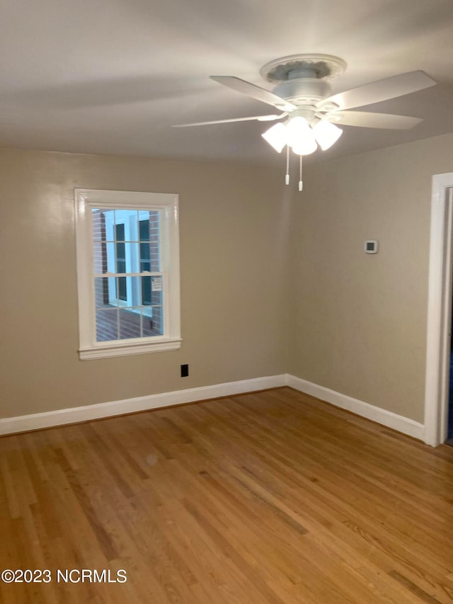 spare room featuring ceiling fan and hardwood / wood-style flooring