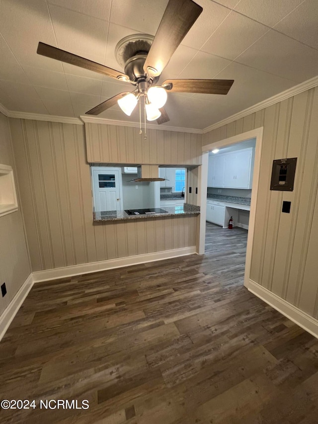 unfurnished living room with ceiling fan and dark wood-type flooring