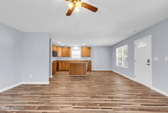 kitchen with a kitchen island, light hardwood / wood-style floors, and ceiling fan