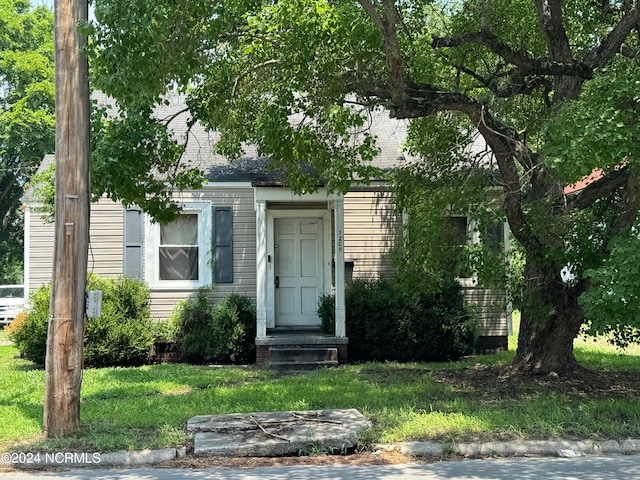 entrance to property with a lawn