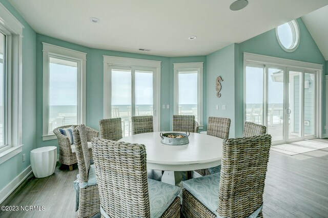 dining space with a water view and light wood-type flooring