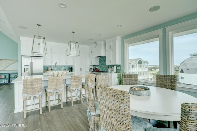 dining room with light hardwood / wood-style flooring and plenty of natural light