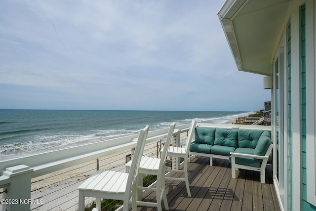 balcony with an outdoor living space and a water view