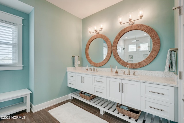 bathroom featuring hardwood / wood-style floors and dual bowl vanity