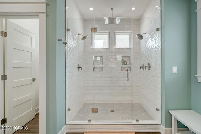 bathroom with walk in shower and wood-type flooring