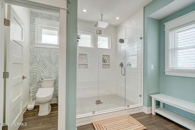 bathroom featuring plenty of natural light, an enclosed shower, hardwood / wood-style floors, and toilet