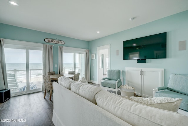 living room with a water view and hardwood / wood-style floors