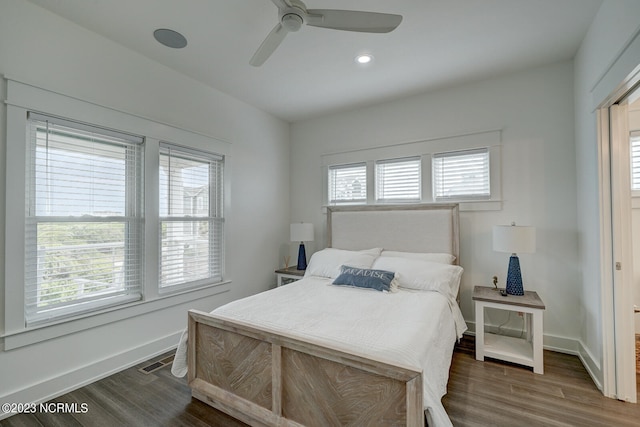 bedroom with ceiling fan and dark wood-type flooring