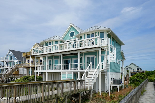 rear view of property with a balcony and central air condition unit