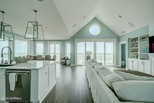 kitchen featuring pendant lighting, sink, stainless steel dishwasher, wood-type flooring, and white cabinetry