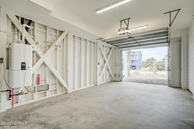 garage featuring a garage door opener and water heater