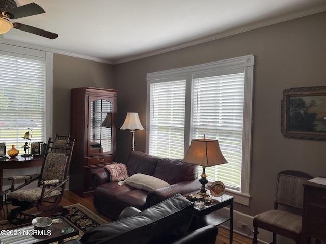 living room with crown molding, ceiling fan, and dark hardwood / wood-style flooring