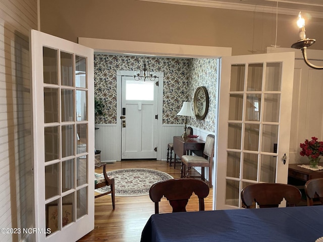 interior space featuring dark hardwood / wood-style flooring, french doors, and crown molding