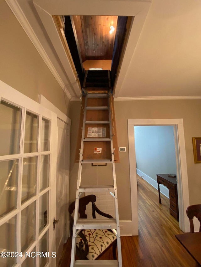 stairs featuring french doors, dark wood-type flooring, ornamental molding, and wood ceiling