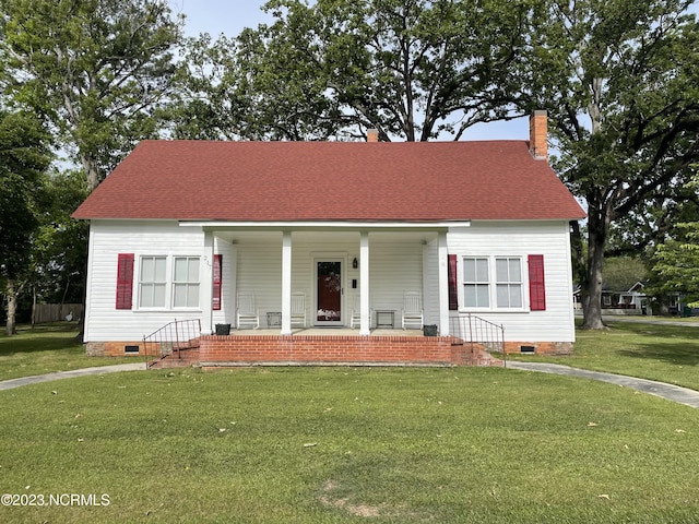 view of front of house with a front yard and covered porch