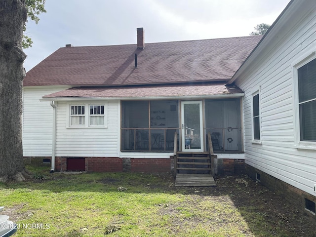 rear view of property with a lawn