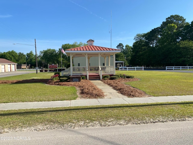 view of front of home featuring a front lawn and a gazebo