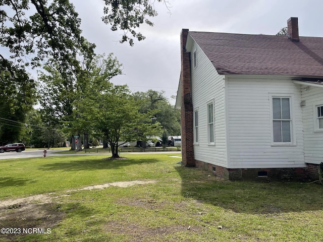 view of side of home featuring a yard