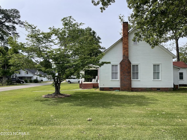 view of property exterior featuring a lawn