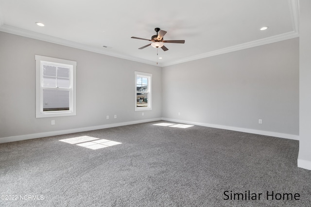 carpeted spare room featuring ornamental molding and ceiling fan