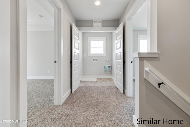 hall with light colored carpet