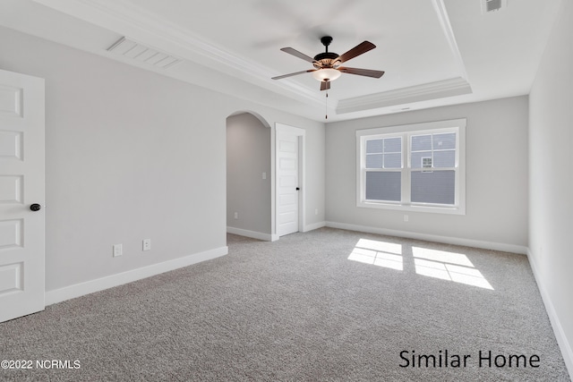 unfurnished room featuring carpet, ceiling fan, and a tray ceiling