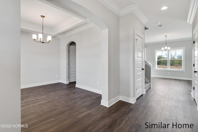 empty room featuring dark hardwood / wood-style floors, a notable chandelier, and crown molding