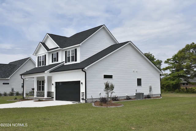 view of side of home featuring a porch, a garage, a yard, and central AC unit