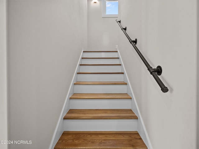 stairway featuring hardwood / wood-style flooring