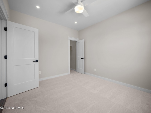 unfurnished bedroom with light colored carpet and ceiling fan