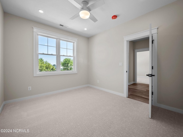 unfurnished room with ceiling fan and carpet flooring