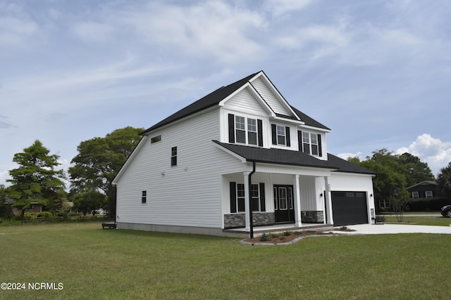 view of front facade with a porch, a garage, and a front yard