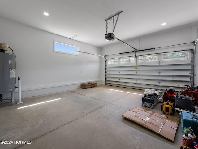 garage with a garage door opener and electric water heater