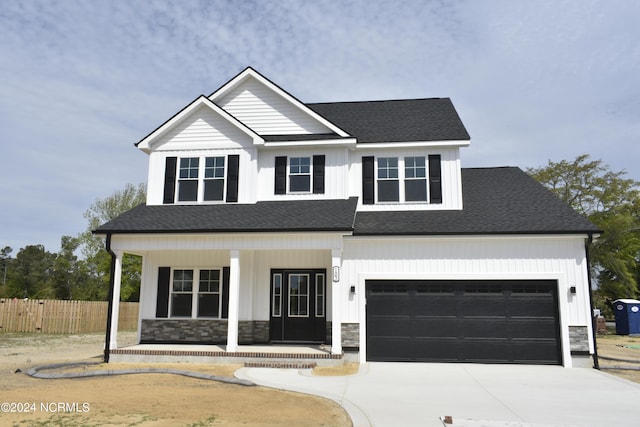 view of front facade with a garage and a porch