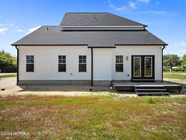 back of property featuring a patio area and a lawn